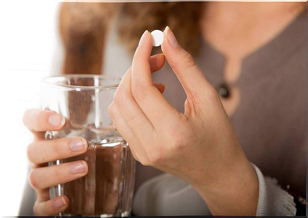 Woman with a pill in her hand