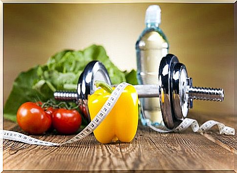 Healthy food, a dumbbell and a tape measure