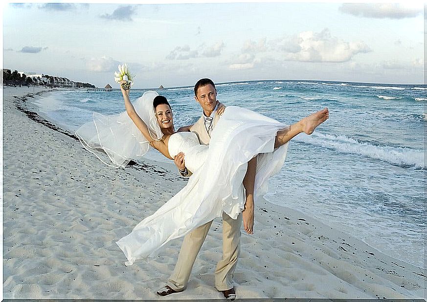 Boyfriend picking up his girlfriend on a beach