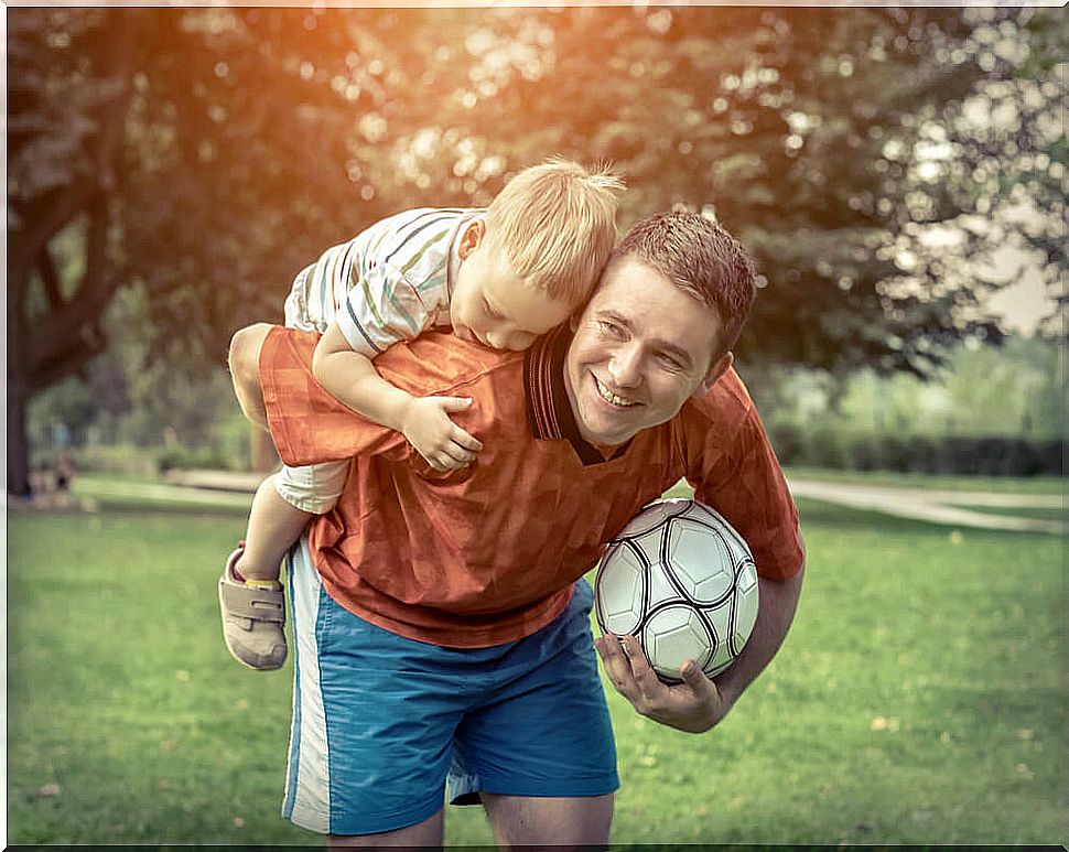 Father plays with his son.