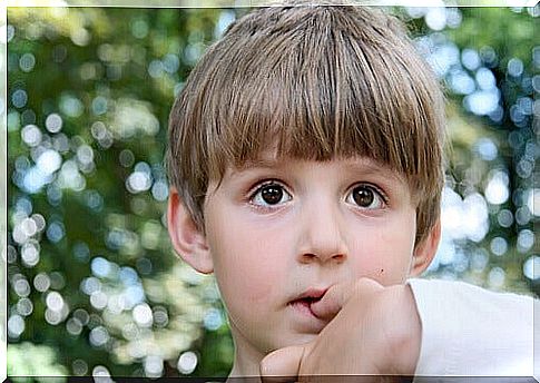 Boy biting his nails