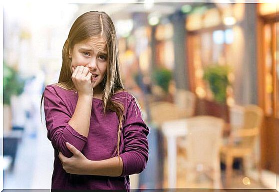 Little girl biting her nails