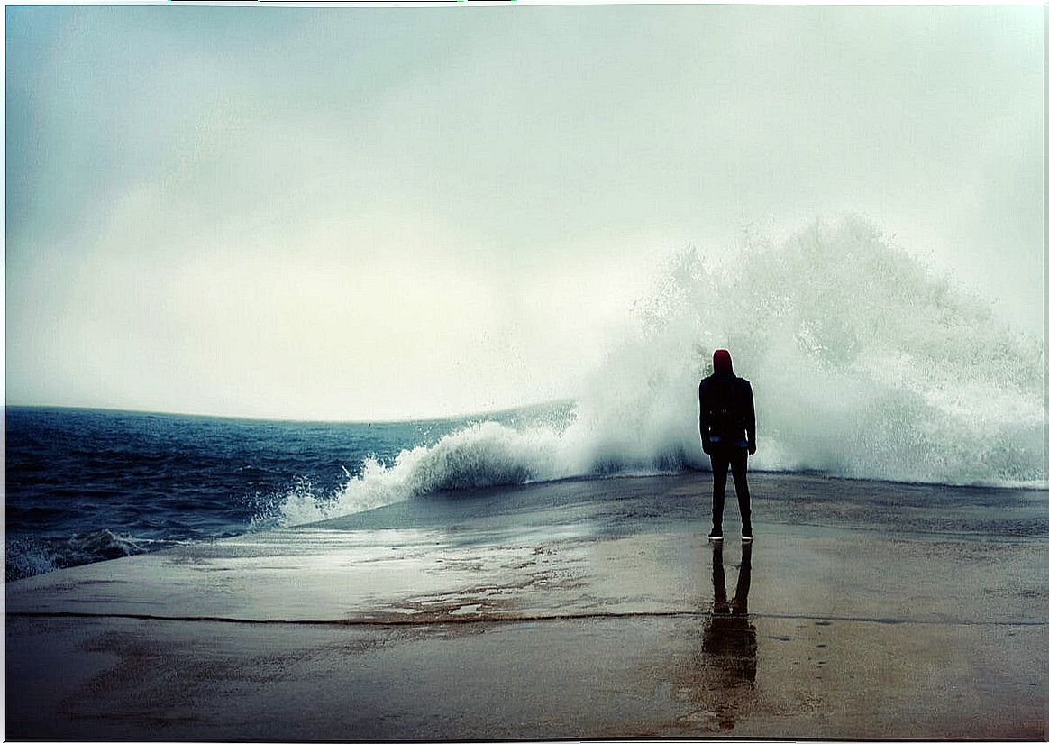 Person in front of the ocean with fear.