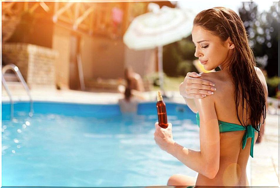 Young man applying cream to get an excellent tan.