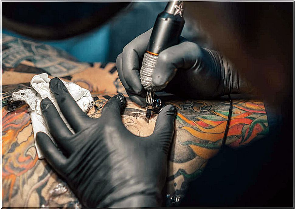 Tattoo artist making a color tattoo.